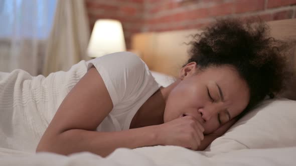 African Woman Coughing While Sleeping in Bed