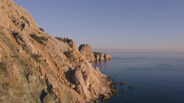 Aerial View of Rocky Coast and Blue Sea