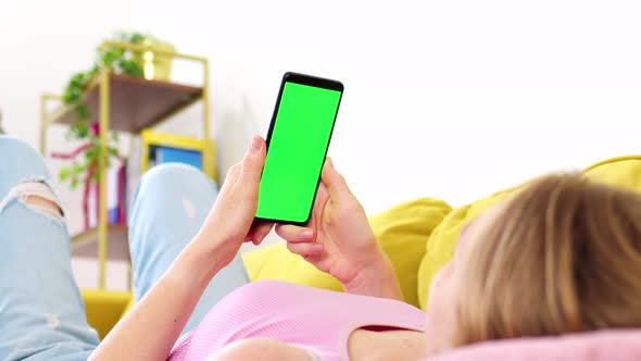 Phone with Green Screen Chroma Key in Hands of Blonde in Pink Top