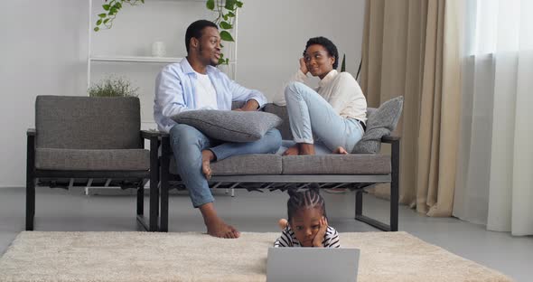 Young Responsible Parents African American Couple Sitting on Couch Talking Speaking While Little