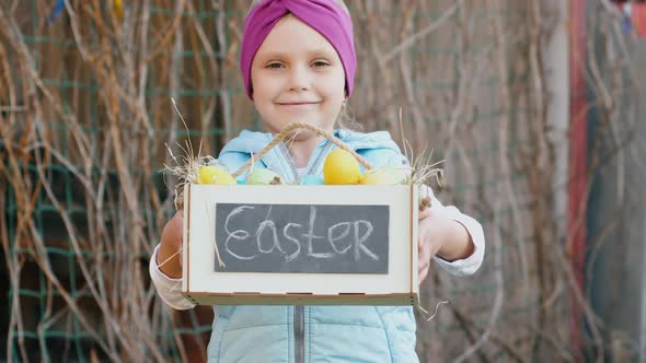 Cute girl hold box with easter eggs