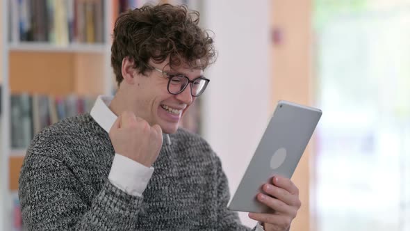 Portrait of Young Man Celebrating on Tablet