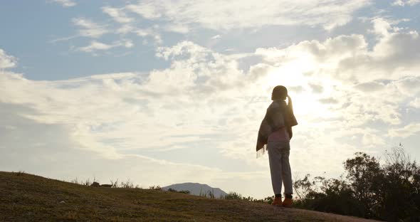 Woman look at the view at sunset time in countryside