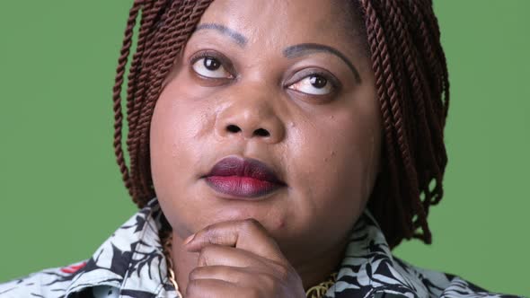 Overweight Beautiful African Woman Against Green Background