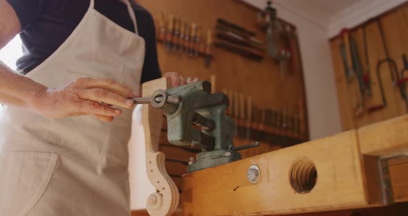 Female luthier at work in her workshop