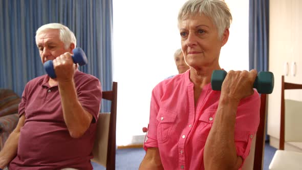 Group of senior people exercising with dumbbells