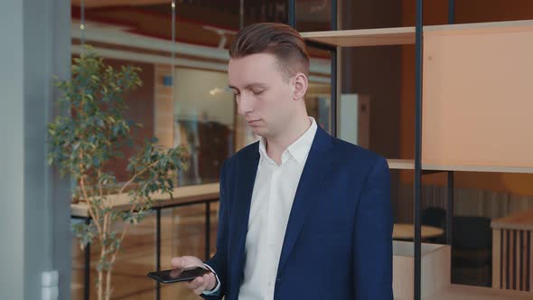 Portrait of a Young Student with a Mobile Phone in a Rutsi