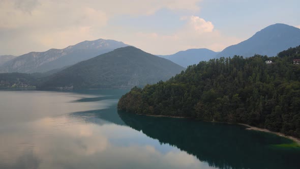 Stunning sight of an overflowing turquoise and crystal clear lake ledro in trentino, north italy