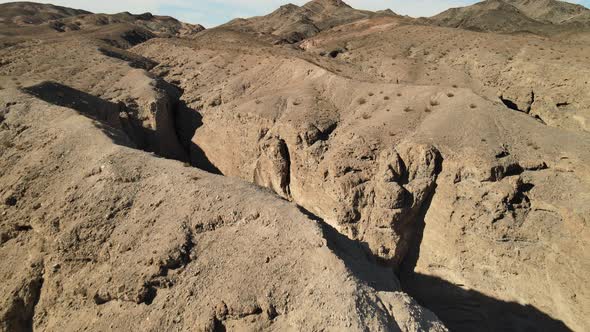 A drone revealing shot of the unique rocky desert landscape of Afton Canyon in the Mojave Desert of