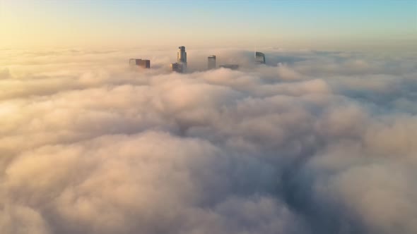 Aerial of the downtown Los Angeles surrounded by clouds