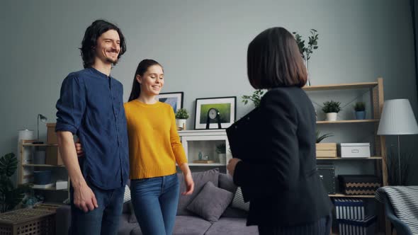 Realtor Giving Key To Girl and Guy Shaking Hands, Happy Owners Kissing Hugging