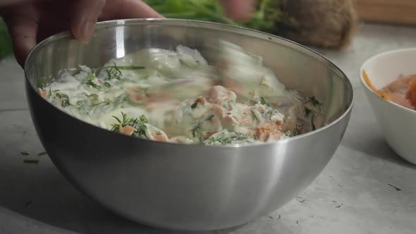 Close up: Chef mixes fresh smorgastarta ingredients in metal bowl