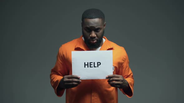 African-American Male Prisoner Holding Help Sign, Asking for Justice, Abuse