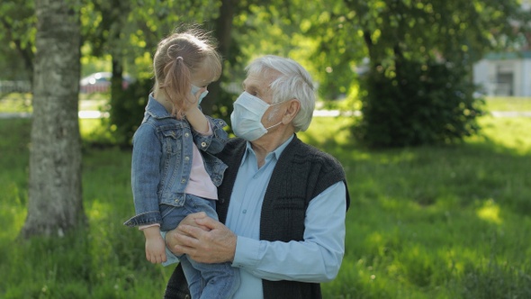 Grandfather with Granddaughter Takes Off Masks After Coronavirus Quarantine End