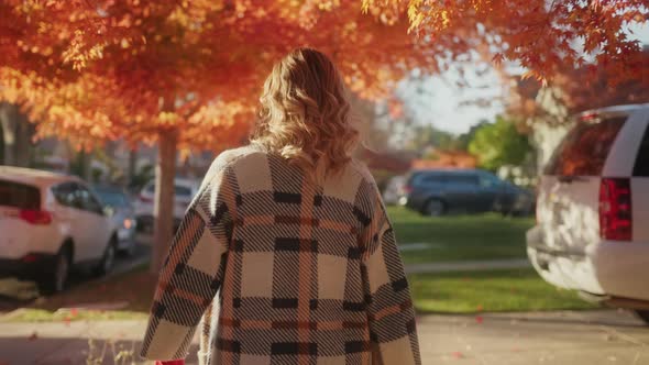 Woman Walking By Sideway Enjoying Warm Sunny Autumn Day