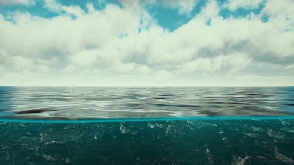 Split View Over and Under Water in the Caribbean Sea with Clouds