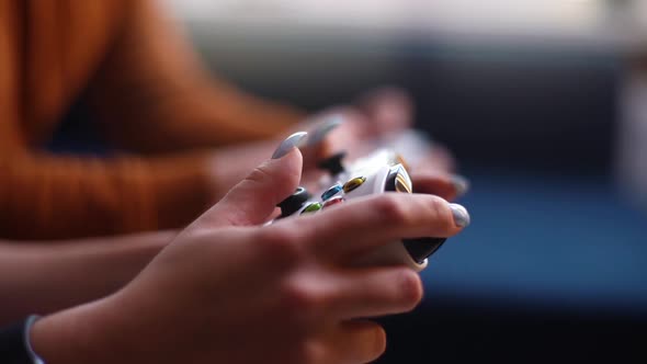 Closeup Hands of Unrecognizable Woman Holding Joystick and Playing Video Games on Console