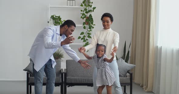 Three People Afro American Family Young Couple Dancing with Their Beloved Preschool Girl Daughter