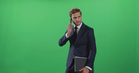 Young Businessman in a Suit Standing and Talking on a Mobile Phone, Top Manager Swears During a