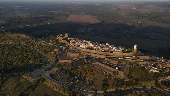 Monsaraz village in rural landscape at sunrise, Portugal. Aerial drone view