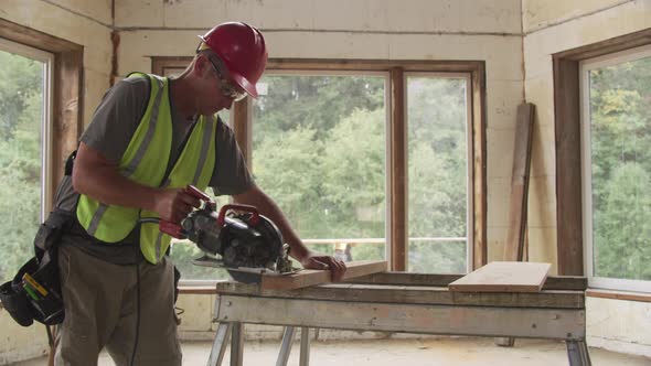 Construction worker cutting board with circular saw