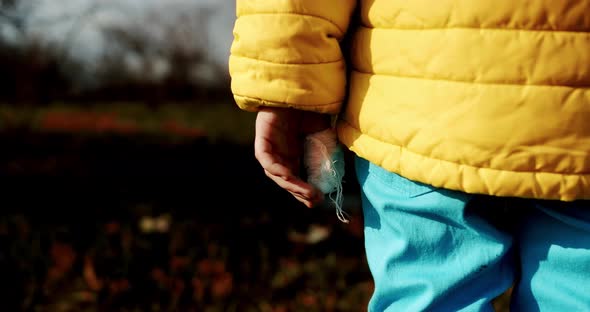 Child Dressed in the Colors of the Ukrainian Flag with the Bandaged Finger