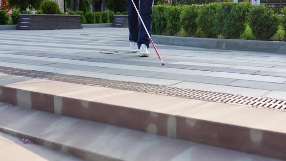 Young Blind Man with Using Safety Stick for Walking Alone Outdoors