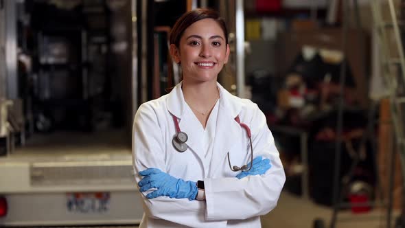 Female medical personnel folding arms and smiling at camera