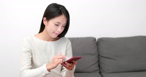 Woman use of mobile phone at home