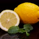 Yellow lemon with mint leaves rotating on a black background. - VideoHive Item for Sale