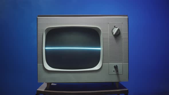 Old Retro Television on Blue Neon Background Closeup