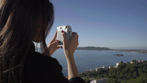 Slow motion shot of female photographer on viewpoint, Ibiza