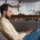 Young Man Freelancer Using Laptop Device While Resting on Sofa at Home Portrait of Male Working - VideoHive Item for Sale