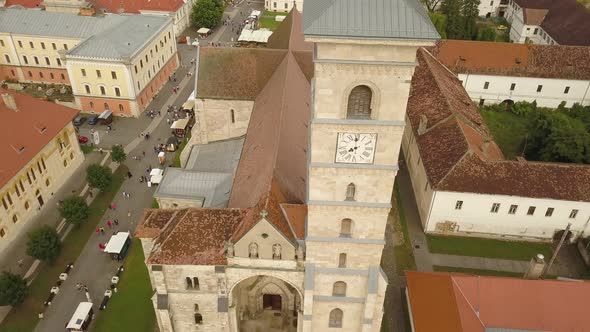 Aerial Establishing shot of Eastern European orthodox church (Romania) with clock on the front and s