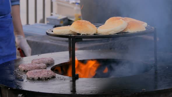 Chef Preparing Burgers at Street Food Festival