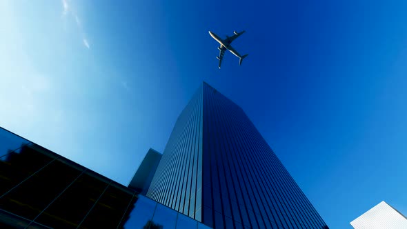 The Plane Flies Over The Buildings