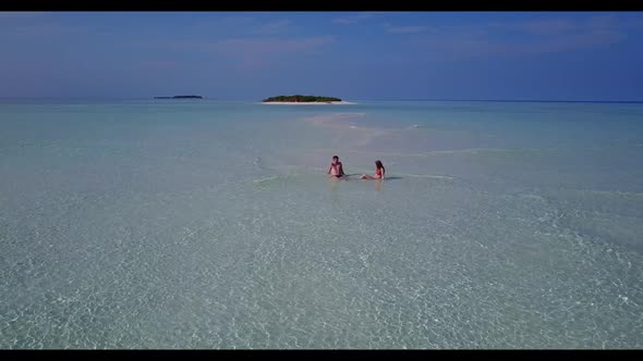 Man and woman suntan on paradise resort beach break by transparent lagoon and white sand background 