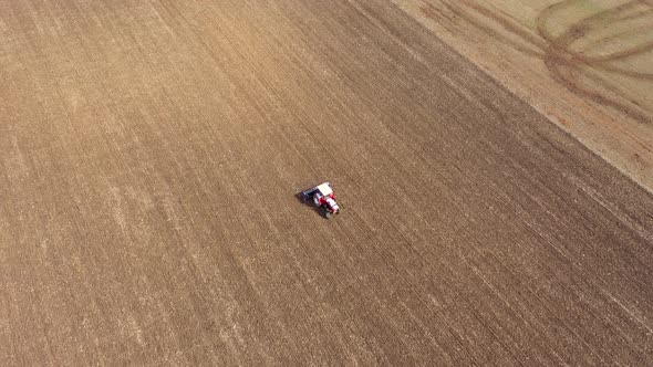 Flying Above a Tractor Plowing the Field