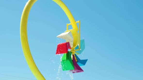 Large Multicolored Fountain Pillar Splashing Water in the Aqua Park Against the Sky