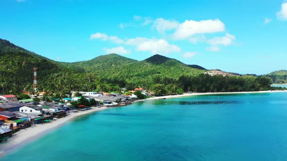 Wide above abstract view of a paradise sunny white sand beach and aqua blue ocean background in colo