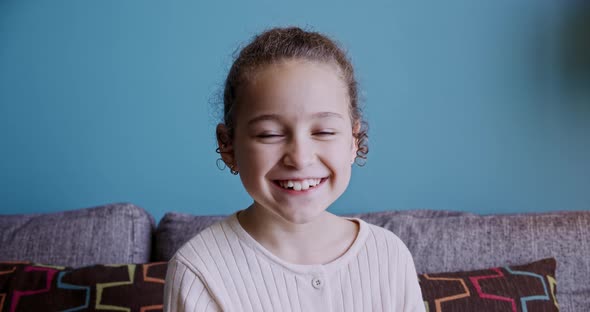 Portrait Funny Little Girl Smiling Child Looking at Camera are Sitting on the Couch at Home Cute Kid