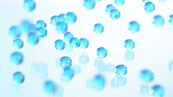 Super Slow Motion Shot of Blue Hydrogel Balls Bouncing on Glass at 1000Fps