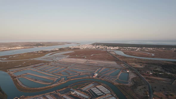 Drone flying backwards over Castro Marim in Portugal revealing the great landscape of its land