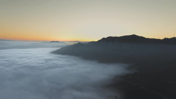 Aerial view over the clouds covering valley at sunset in Malibu Canyon, Calabasas, California, USA