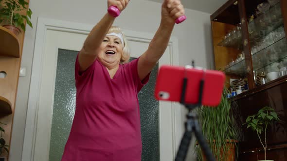 Old Senior Grandmother Woman Doing Workout with Dumbbells Training Fitness Sport Activity at Home