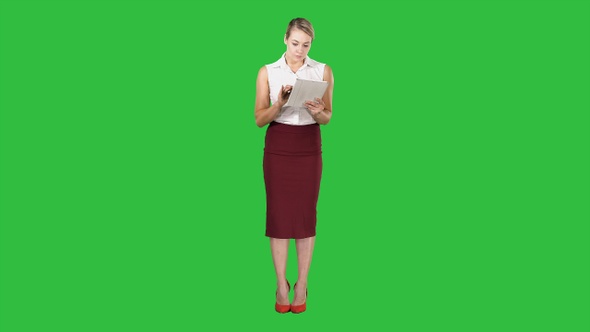 Attractive businesswoman using a digital tablet while standing