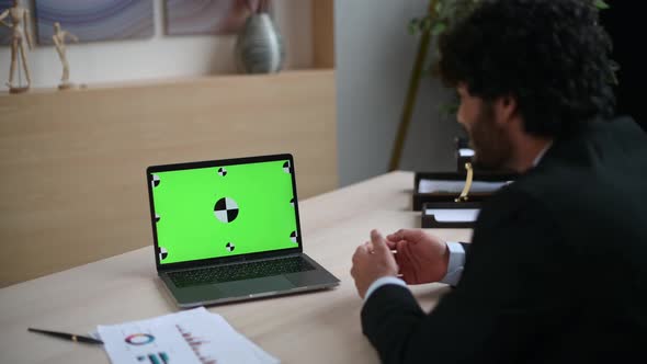 Over the Guy's Shoulder View of a Laptop with a Chromatic Green Screen