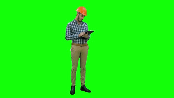 Site Inspector Filing in Inspection Form on a Green Screen, Chroma Key