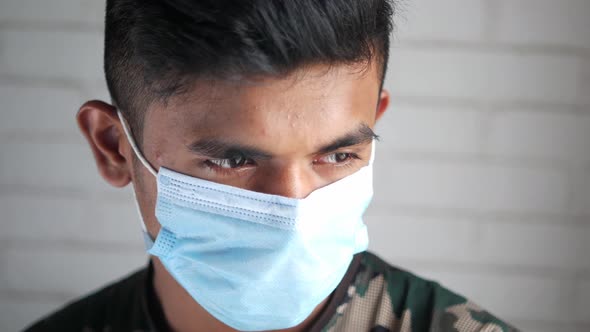 Close Up of Man with Protective Face Mask Looking at Camera