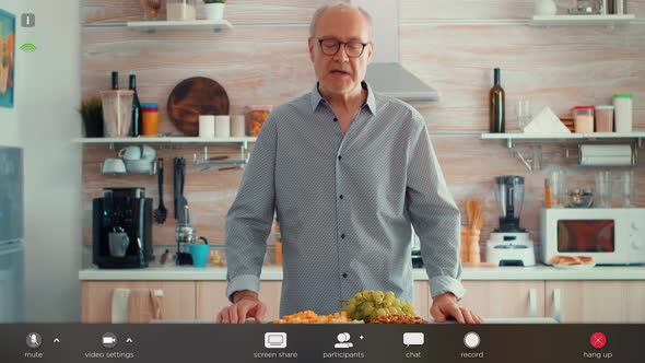 Senior Man Having Video Call in Kitchen